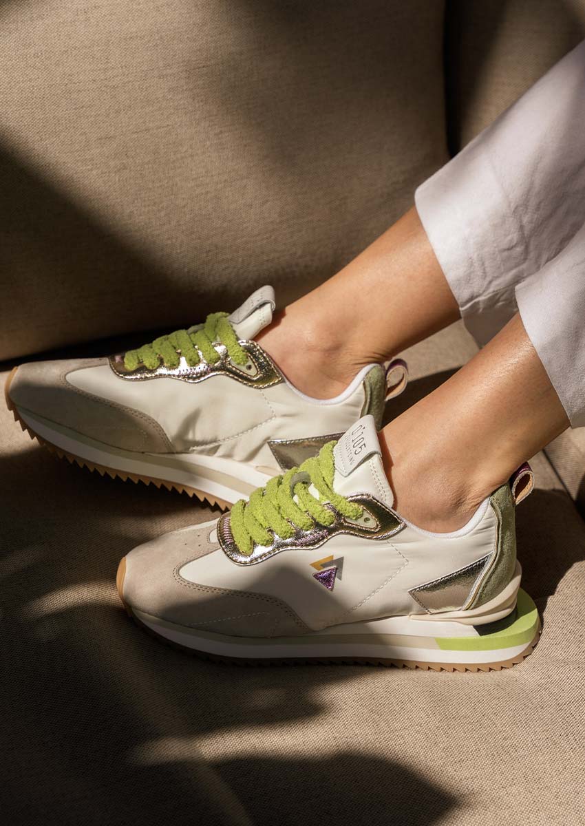 Sneakers 0-105 Lenox Blooming | L'Éclat des Matières & La Lumière Sneakers 0-105 Lenox Blooming blanches lacets verts fourrure détails métalliques argentés posées sur canapé beige jeux d'ombres et lumière naturelle
